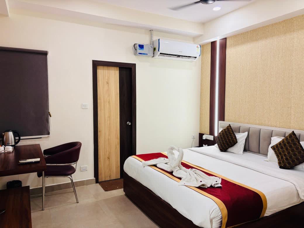Bedroom with a bed, a desk and chair, and an air conditioner
